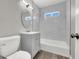 Updated bathroom with gray vanity, bathtub and marble-style tile at 209 N 21St St, Las Vegas, NV 89101