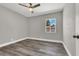 Simple bedroom with grey walls, vinyl flooring and a window at 209 N 21St St, Las Vegas, NV 89101