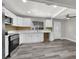 Modern kitchen with white cabinets, new appliances, and wood flooring at 209 N 21St St, Las Vegas, NV 89101