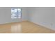 Empty bedroom with a window providing natural light and hardwood floors at 251 S Green Valley Pkwy # 1212, Henderson, NV 89012