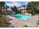 Relaxing community pool area with lounge chairs, palm trees, and inviting cabanas at 251 S Green Valley Pkwy # 1212, Henderson, NV 89012