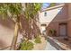 Warm condo entrance framed by mature trees, showcasing a well-lit walkway at 251 S Green Valley Pkwy # 1212, Henderson, NV 89012