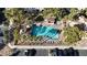 An aerial view of a community pool with palm trees, a covered patio, and lounge chairs at 251 S Green Valley Pkwy # 1212, Henderson, NV 89012