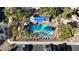 An aerial view of a community pool with palm trees, a covered patio, and lounge chairs at 251 S Green Valley Pkwy # 1212, Henderson, NV 89012