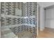 Tiled shower with glass doors, bench, and showerhead, within a gray and white tile design at 251 S Green Valley Pkwy # 1212, Henderson, NV 89012