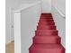 Carpeted staircase featuring a vibrant red carpet runner and bright white walls with matching banisters at 251 S Green Valley Pkwy # 1212, Henderson, NV 89012