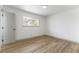 Bedroom with gray door and a window, featuring wood-look floors at 257 Colleen Dr, Las Vegas, NV 89107