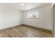 Well-lit bedroom with wood-look floors and a window at 257 Colleen Dr, Las Vegas, NV 89107