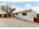 Rear view of house with white exterior and gravel landscaping at 257 Colleen Dr, Las Vegas, NV 89107