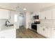 Modern kitchen featuring white cabinets, stainless steel appliances, and quartz countertops at 257 Colleen Dr, Las Vegas, NV 89107