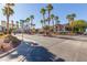 Community entrance and street view with palm trees at 2615 W Gary Ave # 1035, Las Vegas, NV 89123