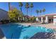 Inviting community pool with palm trees and seating at 2615 W Gary Ave # 1035, Las Vegas, NV 89123