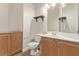 Bathroom boasts wood cabinets and a corner vanity with a large mirror at 2730 Morning Break Ct, Las Vegas, NV 89142