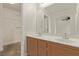 Double vanity bathroom with wood cabinets and a large mirror at 2730 Morning Break Ct, Las Vegas, NV 89142