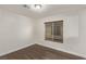 Bright bedroom featuring wood-look flooring and window blinds at 2730 Morning Break Ct, Las Vegas, NV 89142