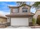 Two-story house with attached garage, landscaping, and driveway at 2730 Morning Break Ct, Las Vegas, NV 89142