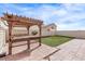 Wooden pergola with patio furniture and grassy backyard at 2730 Morning Break Ct, Las Vegas, NV 89142