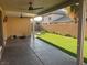 Spacious covered patio with ceiling fans looks out onto a well-manicured backyard at 2821 White Peaks Ave, North Las Vegas, NV 89081