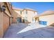 View of backyard featuring a three-car garage and a large concrete area for activities at 2821 White Peaks Ave, North Las Vegas, NV 89081