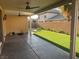 Covered patio with ceiling fans, spacious backyard, and grassy area at 2821 White Peaks Ave, North Las Vegas, NV 89081