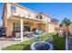 Spacious backyard featuring a covered patio, artificial grass, and recreational play area at 2821 White Peaks Ave, North Las Vegas, NV 89081