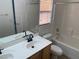 Bright bathroom with a double sink vanity and a shower over the tub at 2821 White Peaks Ave, North Las Vegas, NV 89081