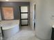 Bathroom with a large soaking tub and sliding door at 2821 White Peaks Ave, North Las Vegas, NV 89081