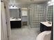 Bathroom featuring dual vanities and a walk in closet at 2821 White Peaks Ave, North Las Vegas, NV 89081