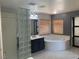 Bathroom featuring glass block shower, a vanity, and a soaking tub by the window at 2821 White Peaks Ave, North Las Vegas, NV 89081