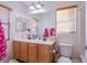 Bathroom with double sink vanity, large mirror, and wood blinds at 2821 White Peaks Ave, North Las Vegas, NV 89081