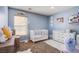 Cozy Bedroom features a crib, changing table, and soft decor at 2821 White Peaks Ave, North Las Vegas, NV 89081