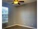 Bright bedroom featuring a window with blinds and ceiling fan, enhancing the room's appeal at 2821 White Peaks Ave, North Las Vegas, NV 89081