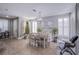 Bright dining room featuring a modern chandelier, white shutters, and a tile floor at 2821 White Peaks Ave, North Las Vegas, NV 89081