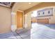 Covered driveway and front door of a tan two-story home with an attached garage at 2821 White Peaks Ave, North Las Vegas, NV 89081