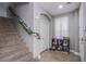 Neutral entryway featuring a carpeted staircase and shoe storage, illuminated by recessed lighting at 2821 White Peaks Ave, North Las Vegas, NV 89081