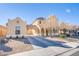 Inviting home with covered driveway, two-story design, and low-maintenance desert landscaping at 2821 White Peaks Ave, North Las Vegas, NV 89081