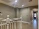 Upstairs hallway with tile flooring and railing at 2821 White Peaks Ave, North Las Vegas, NV 89081