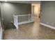 Hallway with tile floors and white railing leads to a bathroom at 2821 White Peaks Ave, North Las Vegas, NV 89081