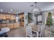 Open floor plan with a dining area that connects to a kitchen with wooden cabinetry at 2821 White Peaks Ave, North Las Vegas, NV 89081