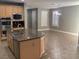 Kitchen island with double sink and breakfast bar at 2821 White Peaks Ave, North Las Vegas, NV 89081