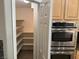 Stainless steel appliances and a walk in pantry adjacent to the kitchen at 2821 White Peaks Ave, North Las Vegas, NV 89081