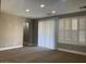 Living room with sliding door and plantation shutters at 2821 White Peaks Ave, North Las Vegas, NV 89081