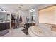 Luxurious main bathroom featuring a soaking tub, glass block partition, and dual vanities at 2821 White Peaks Ave, North Las Vegas, NV 89081