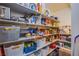 Organized pantry with shelving stocked with food items and storage baskets at 2821 White Peaks Ave, North Las Vegas, NV 89081