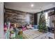 Spacious playroom with decorative wood-look wall and a variety of toys and natural lighting at 2821 White Peaks Ave, North Las Vegas, NV 89081