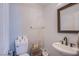 Clean powder room with a sleek vessel sink, dark hardware, and neutral finishes at 2821 White Peaks Ave, North Las Vegas, NV 89081