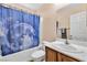 Clean bathroom with a tub, sink, and shower curtain at 3041 Bublin Bay Ave, North Las Vegas, NV 89081