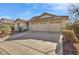 Single story home with a three car garage and desert landscaping at 3041 Bublin Bay Ave, North Las Vegas, NV 89081