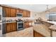 Kitchen features granite countertops, stainless steel appliances, and ample wood cabinetry at 3041 Bublin Bay Ave, North Las Vegas, NV 89081