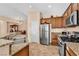 Spacious kitchen with granite countertops, stainless steel appliances, and wood cabinets at 3041 Bublin Bay Ave, North Las Vegas, NV 89081